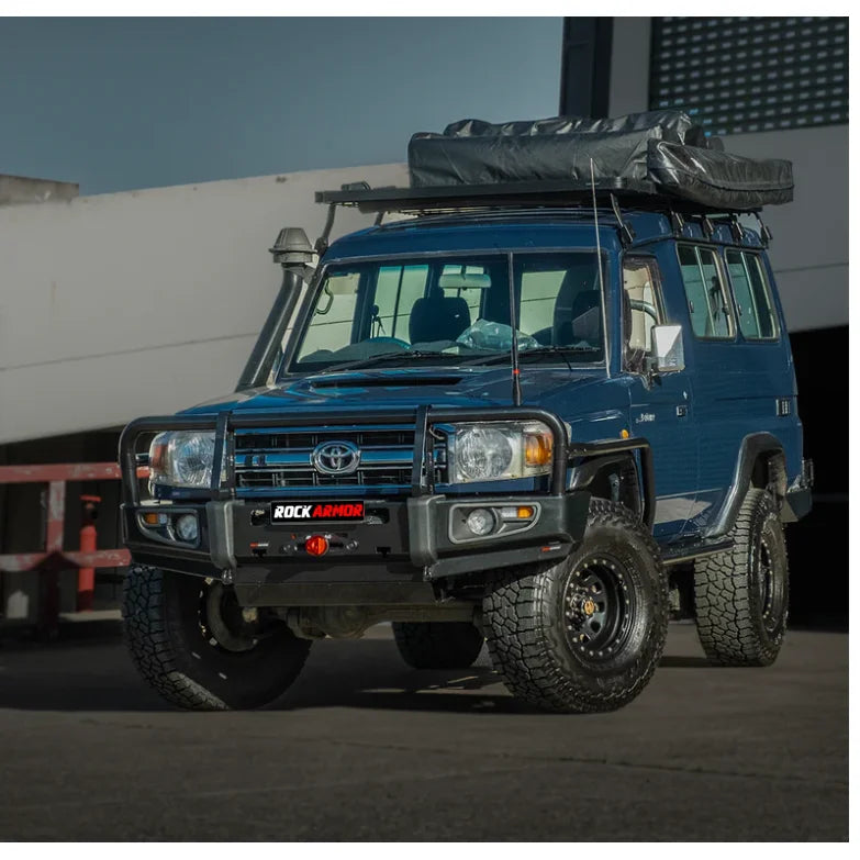 Blue off-road toyota troopy carrier with roof tent featuring rockarmor rockslider for rugged protection