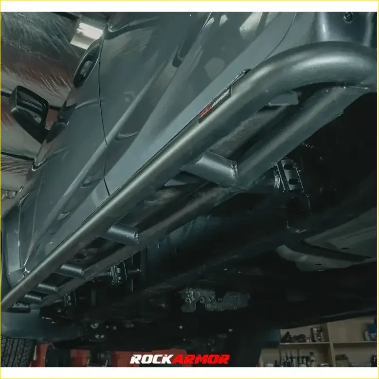 Black metal rock guard with rugged tubular design and visible welds for toyota landcruiser rockarmor rock pack