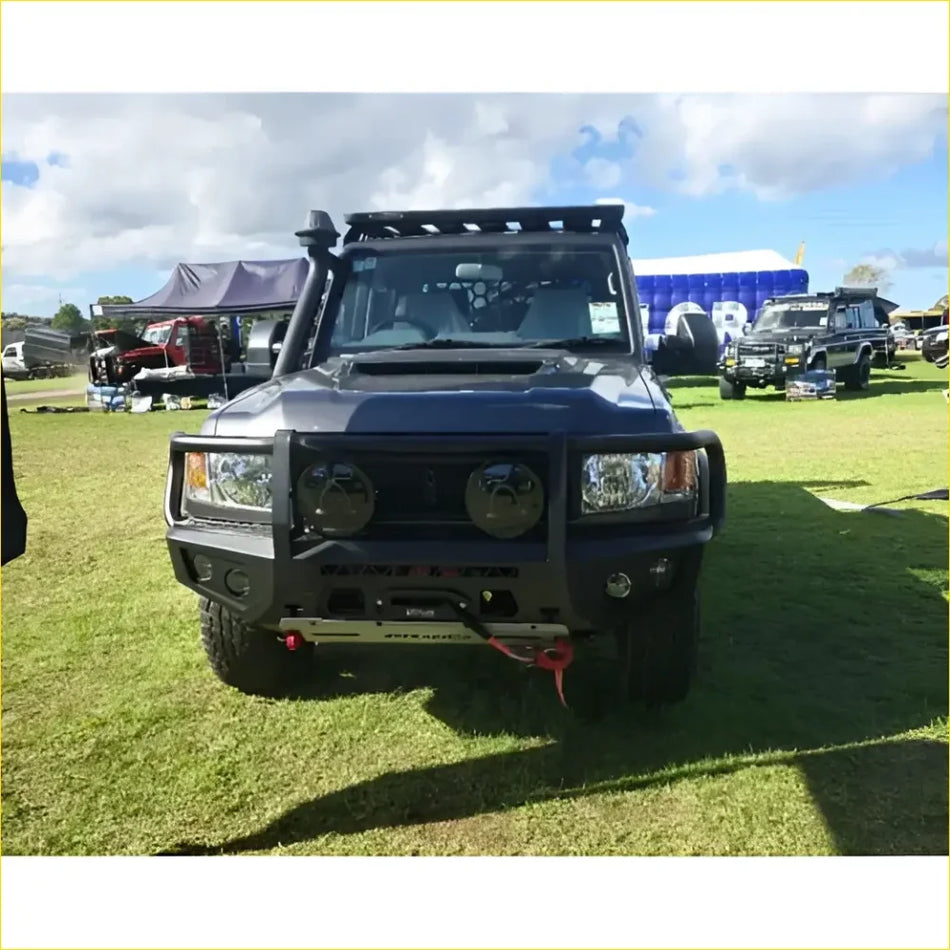 Black armored off-road toyota landcruiser 78 troopy with rugged gt hoop bullbar rock sliders and roof rack