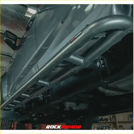 Black metal rock sliders with rugged tubular design and visible welds for toyota landcruiser 79 rockarmor rock pack