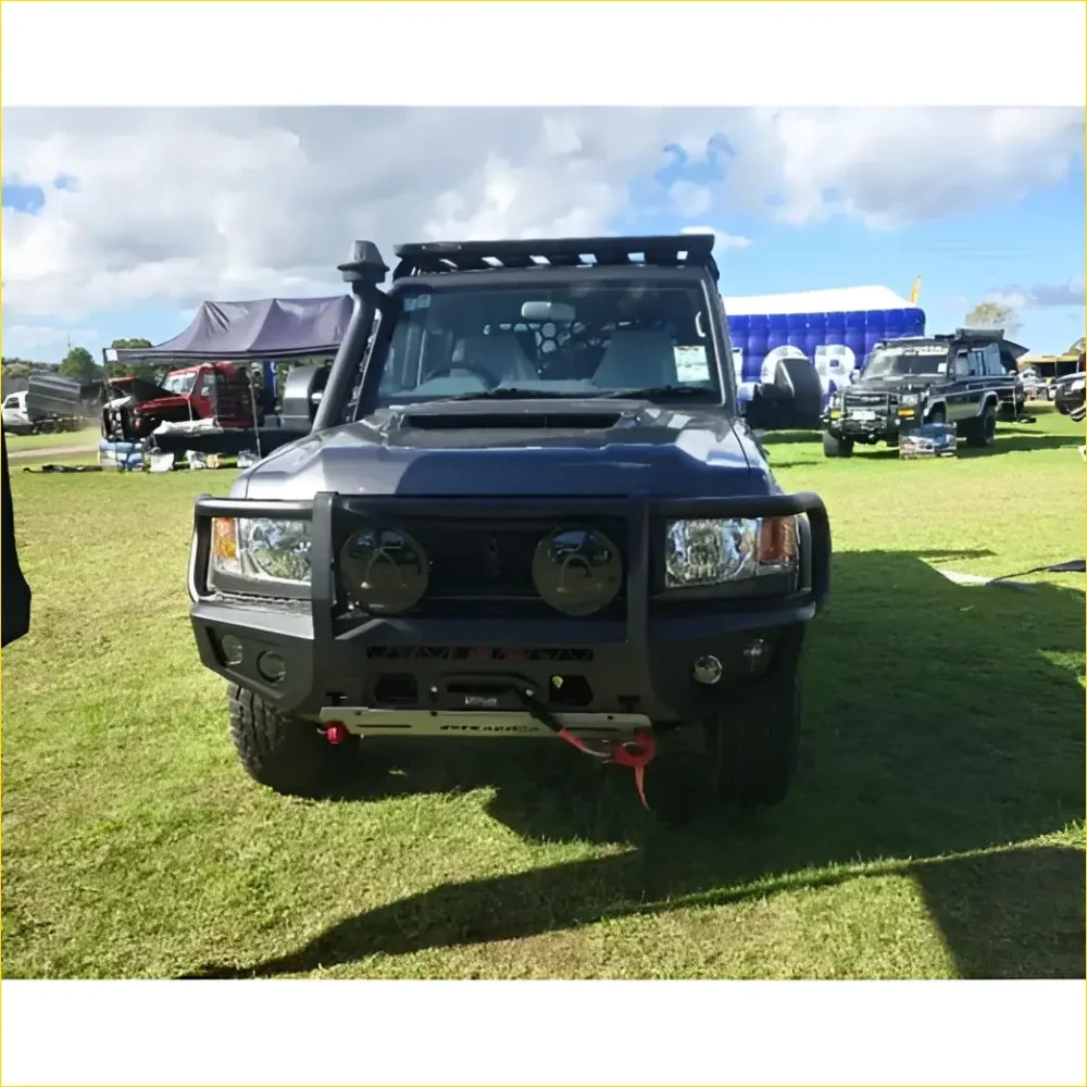 Black armored Toyota Landcruiser 79 with gt hoop bullbar and roof rack for off-road protection and utility