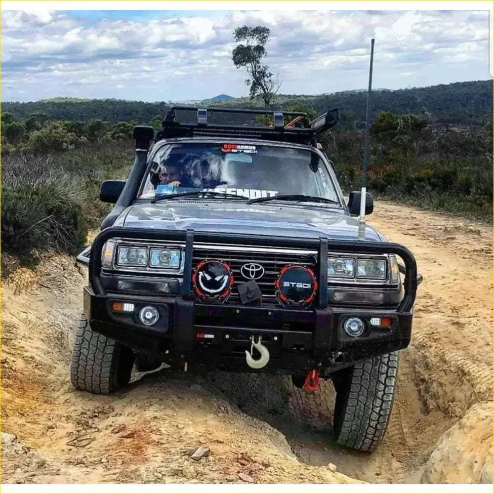 Black toyota landcruiser fj80 with rugged rockarmor rock pack bullbar and rock sliders for off-road toughness