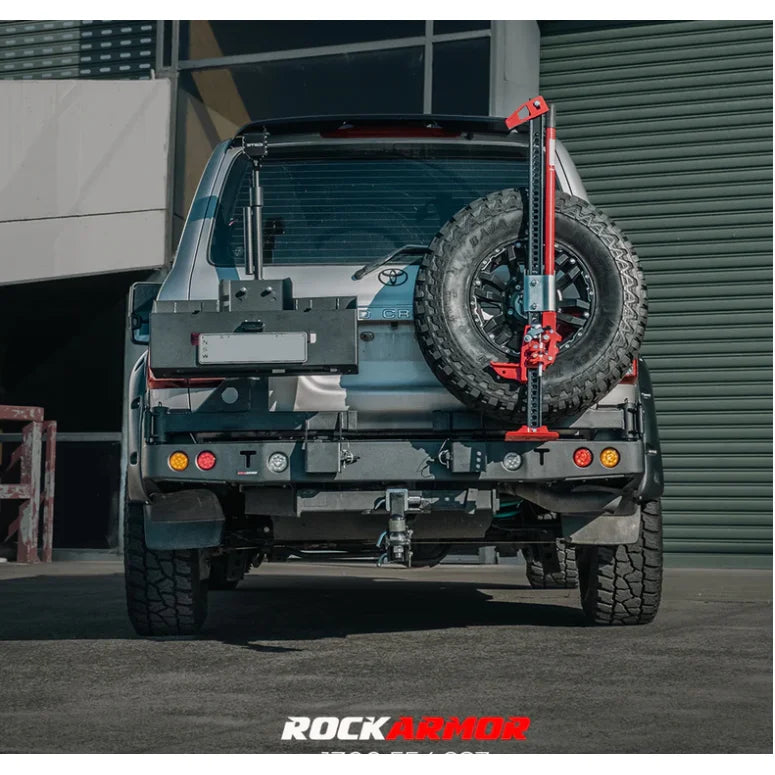 Rear view of silver toyota landcruiser fj105 with rockarmor steel dual wheel carrier and rear-mounted spare tire jack