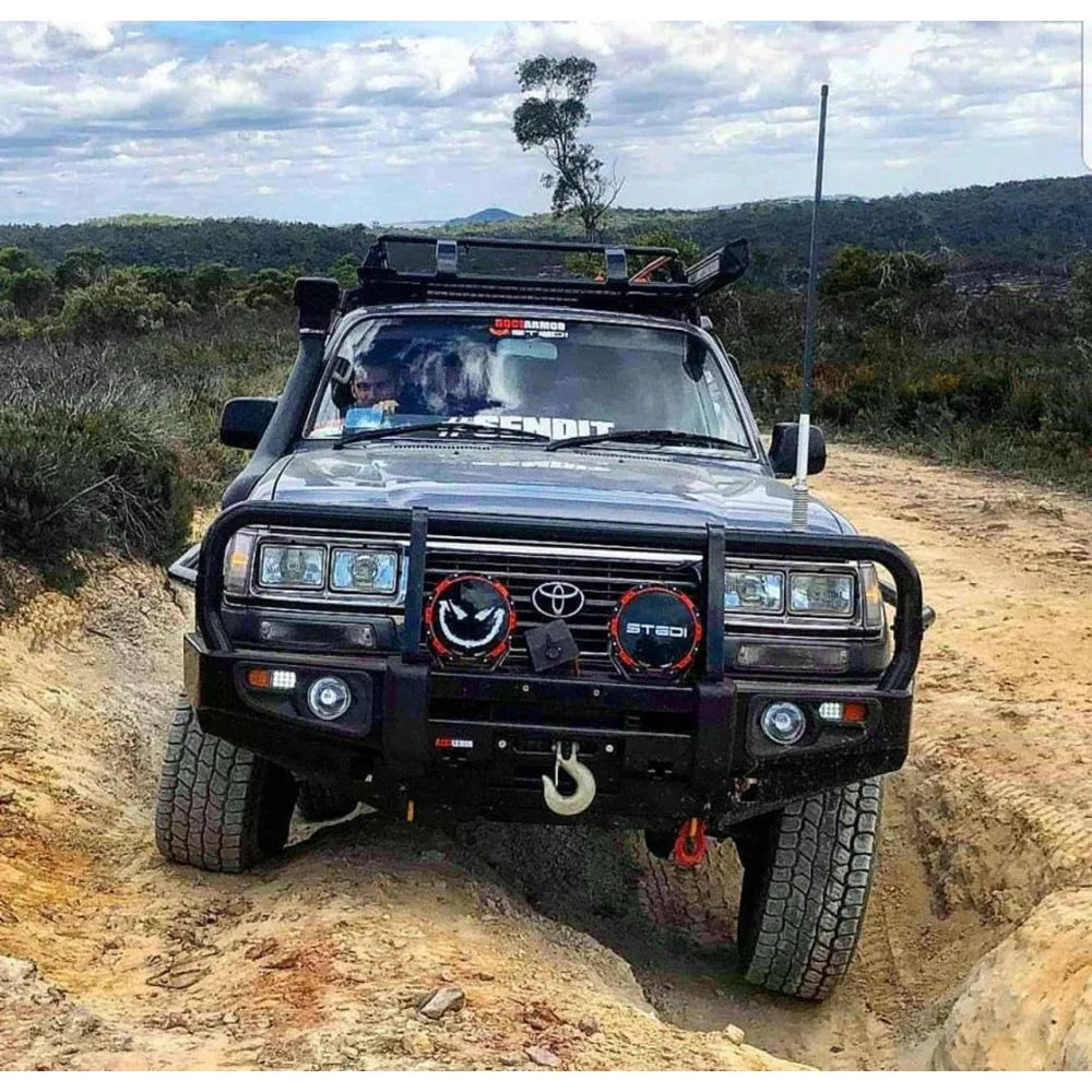 Black off-road Toyota Landcruiser Fj80 equipped with Rockarmor premium steel bullbar and integrated LED fog lights