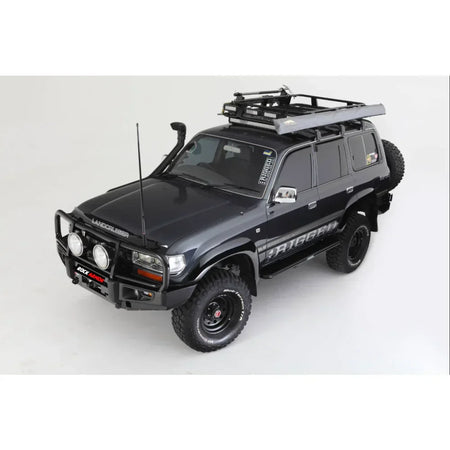 Black Toyota Landcruiser Fj80 with rockarmor premium steel bullbar and roof rack featuring led fog lights