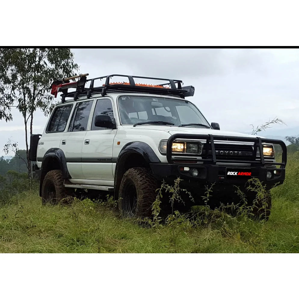 White toyota landcruiser fj80 with rockarmor premium steel bullbar and roof rack featuring led fog lights